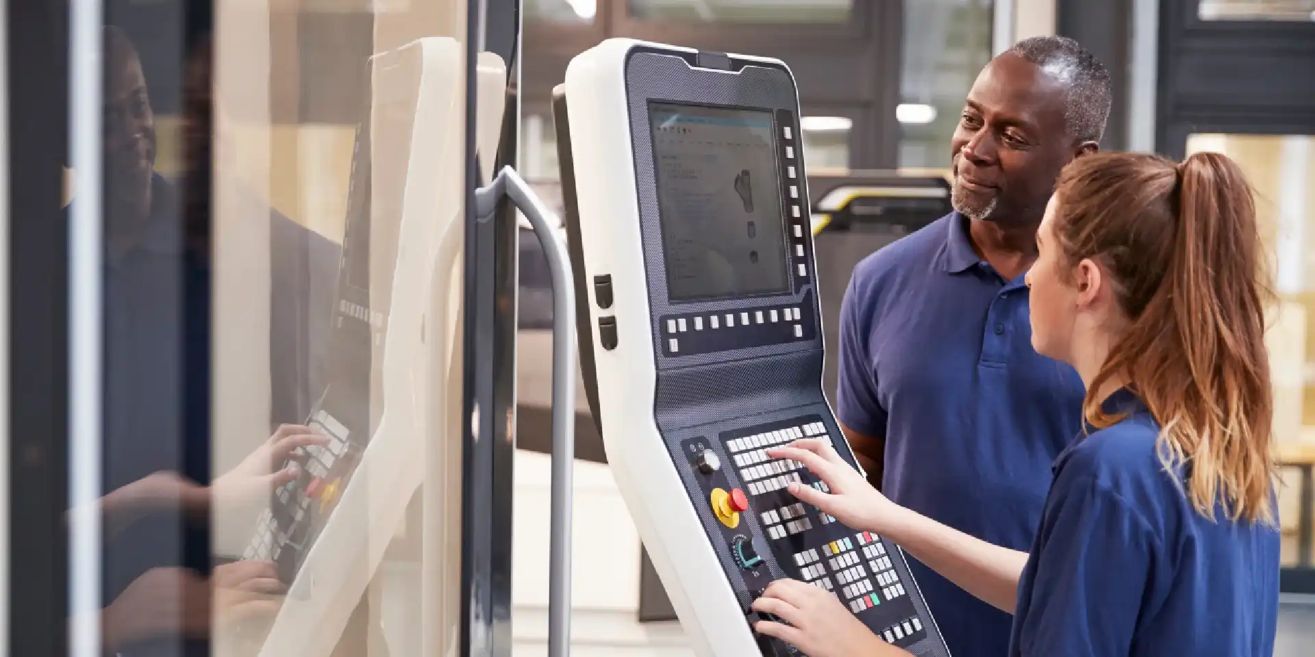 Engineers looking at CNC machine