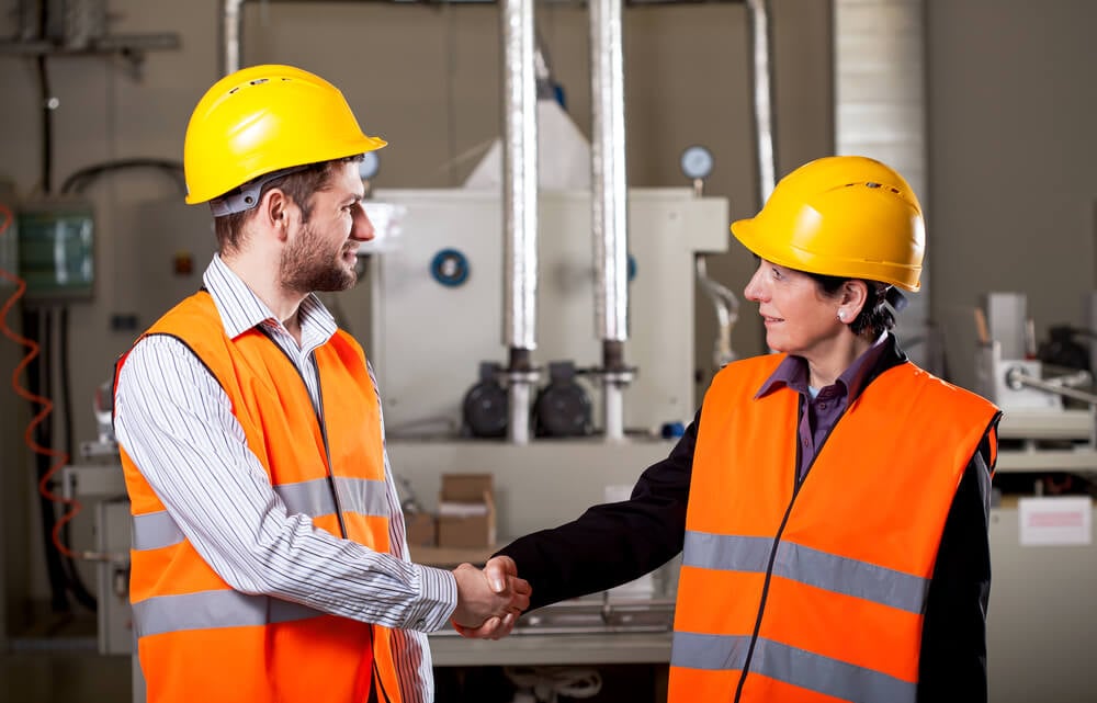 Female worker shake hand with male worker Female worker shake hand with male worker